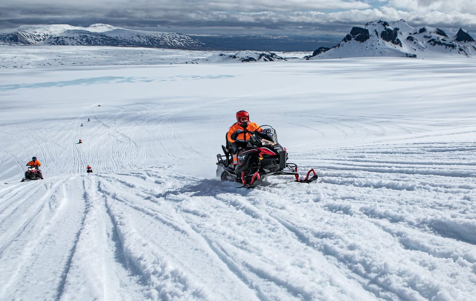 From Geysir: Snowmobiling & Ice Cave on Langjökull Glacier - The ice cave stop: blue light, ash-striped walls, and great photo moments